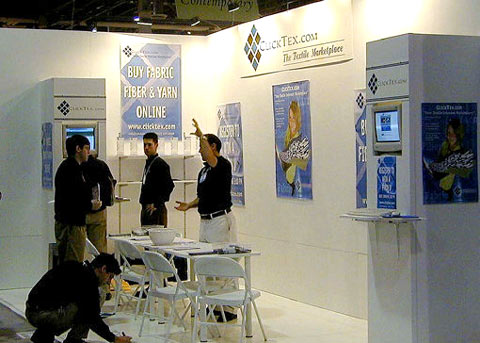 ClickTex booth with computer work stations and masonite floor by Manny Stone Decorators