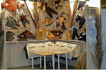 corner booth with adjustable rack system by Manny Stone Decorators